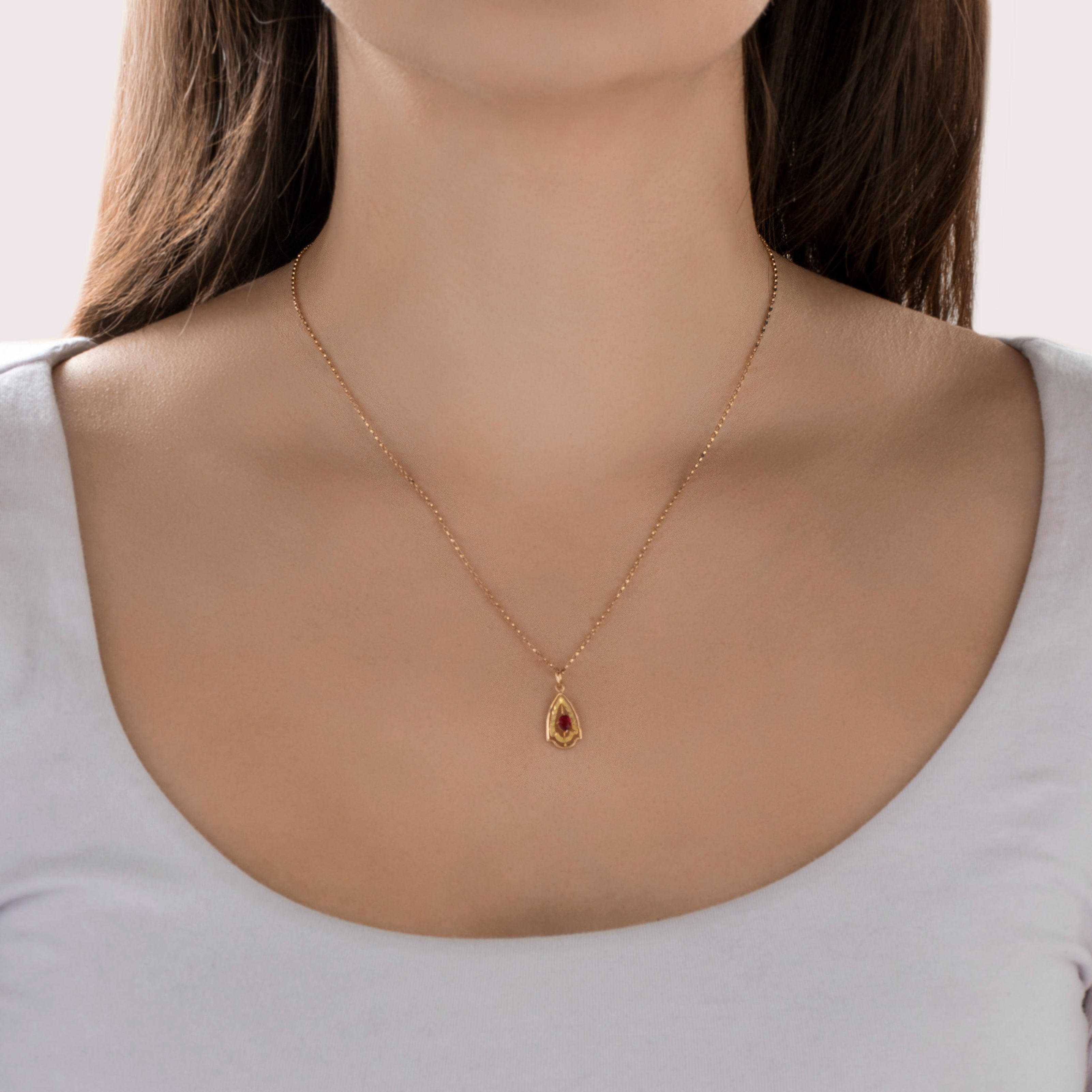 Antique Victorian 14k Yellow Gold Red Glass Lightweight Detailed Textured Pear Border Pendant - On model view