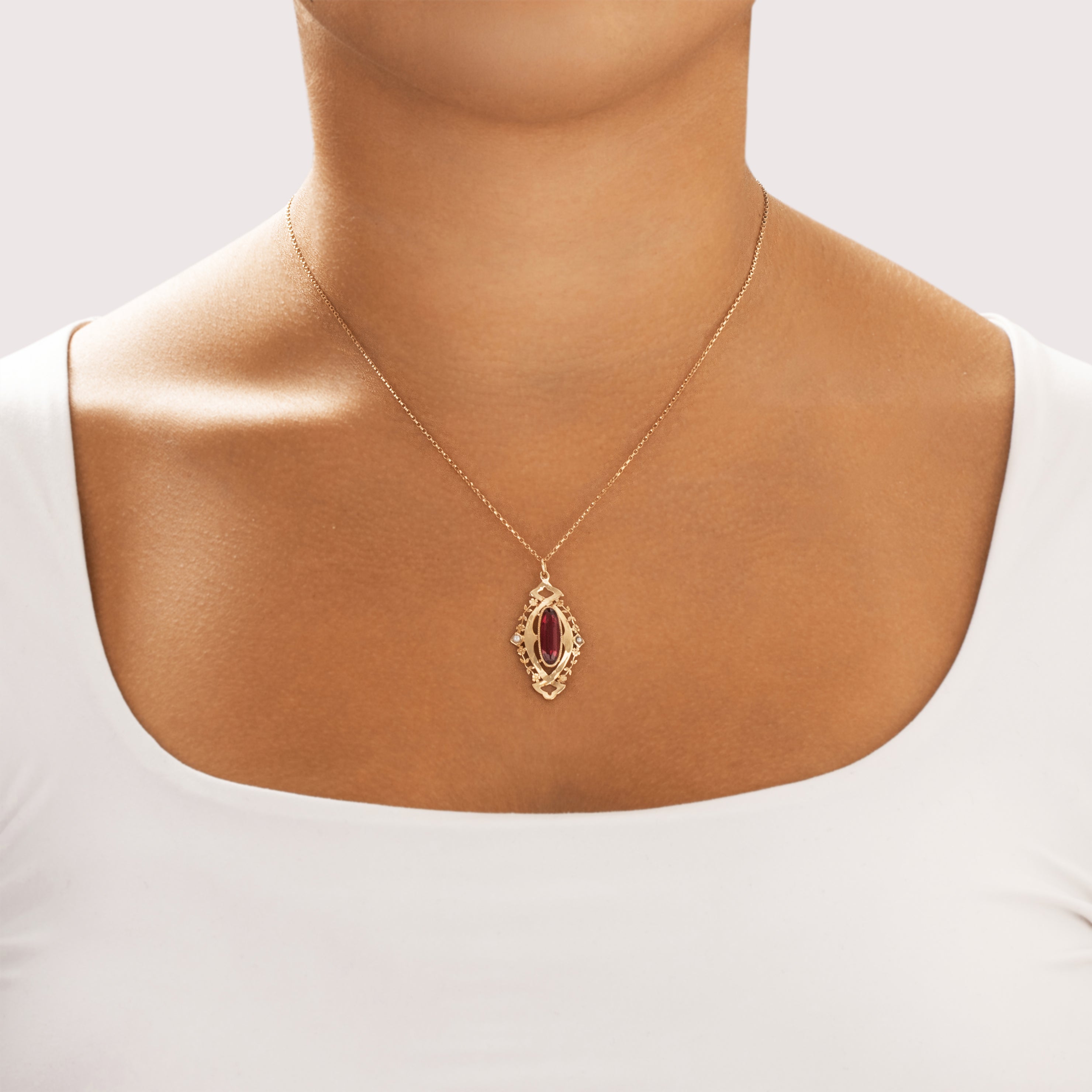 Antique 10k Yellow Gold Dark Pink Garnet Glass Doublet Pearl Floral Openwork Filigree Pendant - On model view