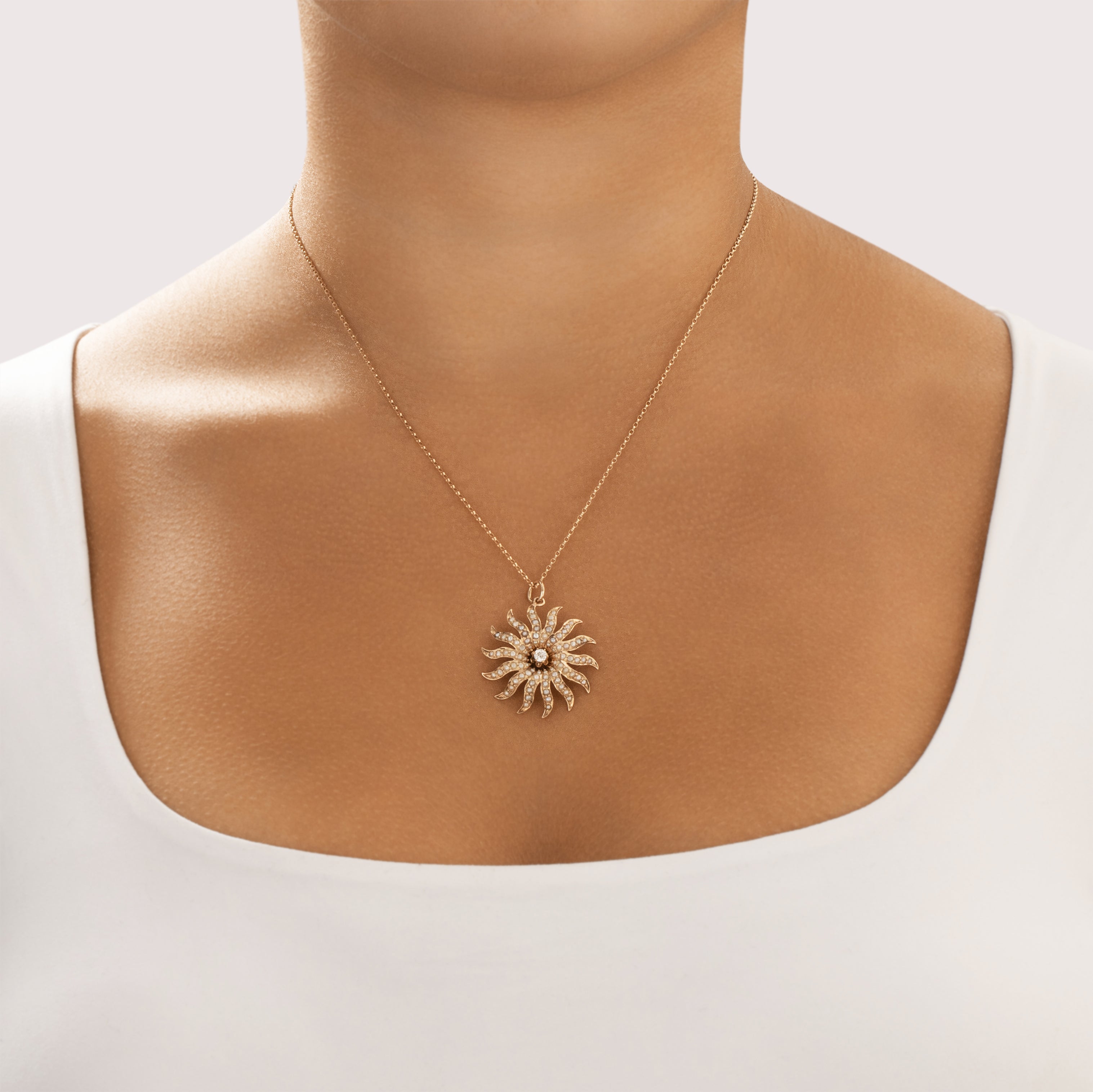 Antique 10k Rosy Yellow Gold Old European Cut Diamond Seed Pearl Glowing Swirling Sun Pendant - On model view