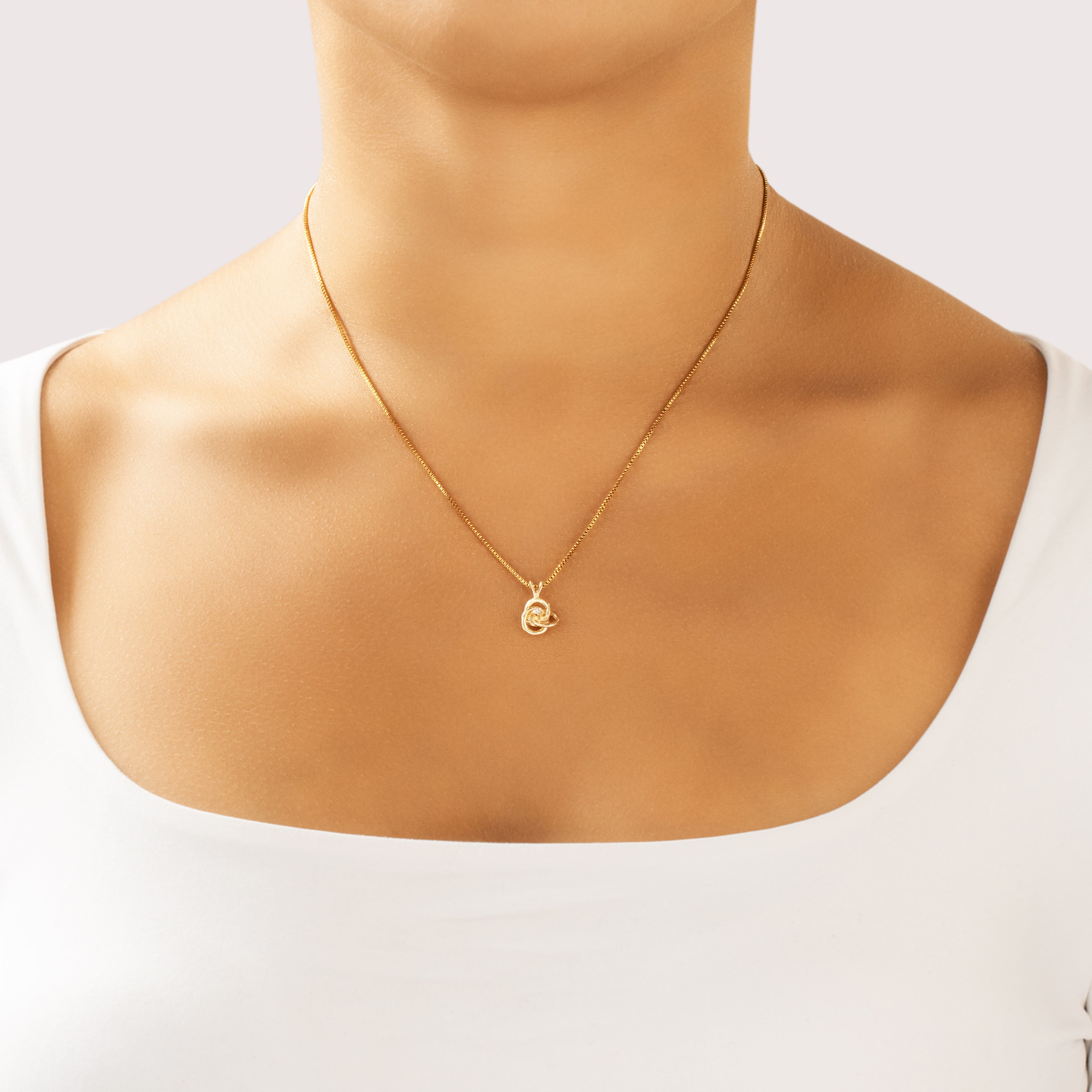 Vintage Small 14k Yellow Gold Diamond Interlocking Knot Solitaire Pendant - On model view