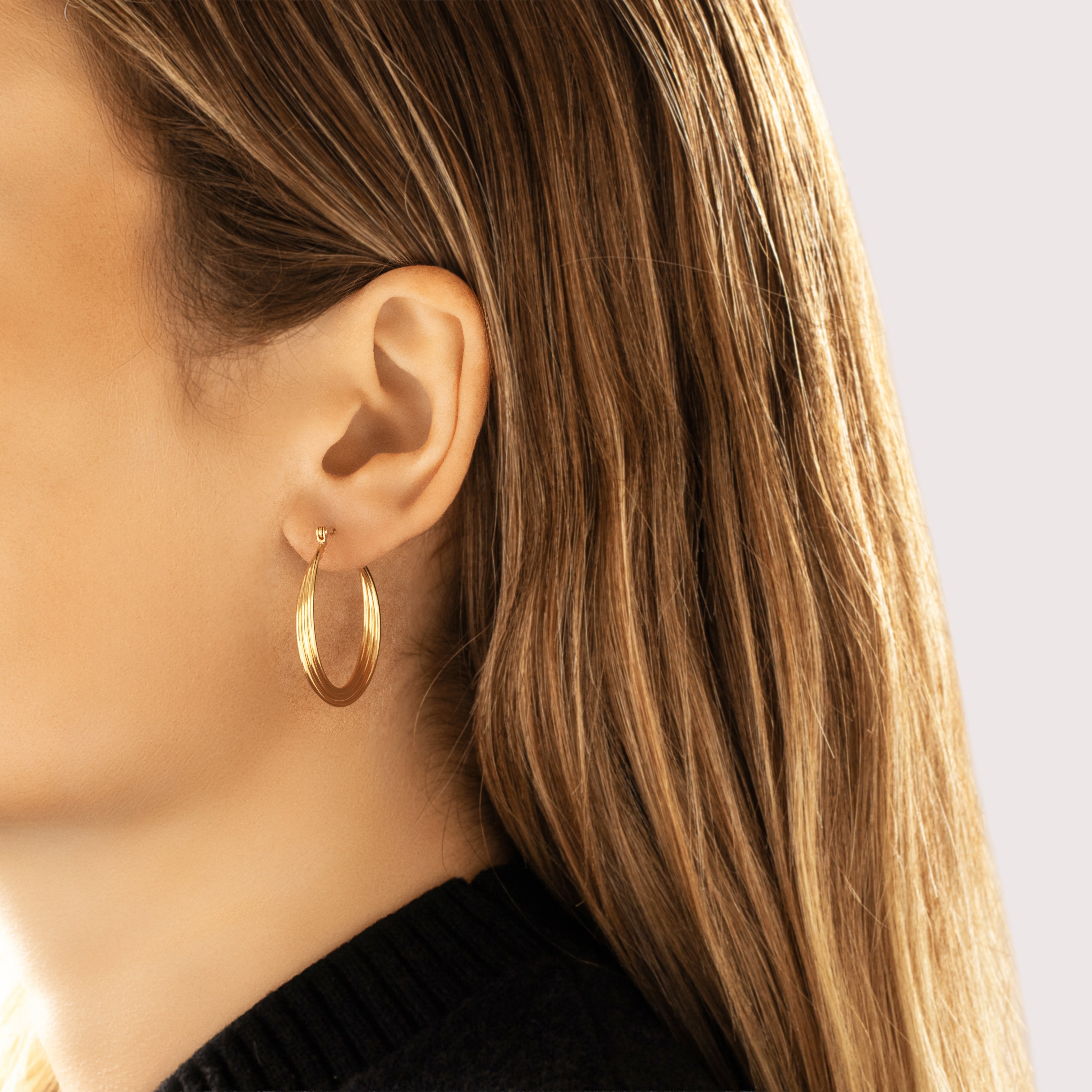 Vintage Large 14k Yellow Gold Twisting Tube Hoop Earrings - On model view