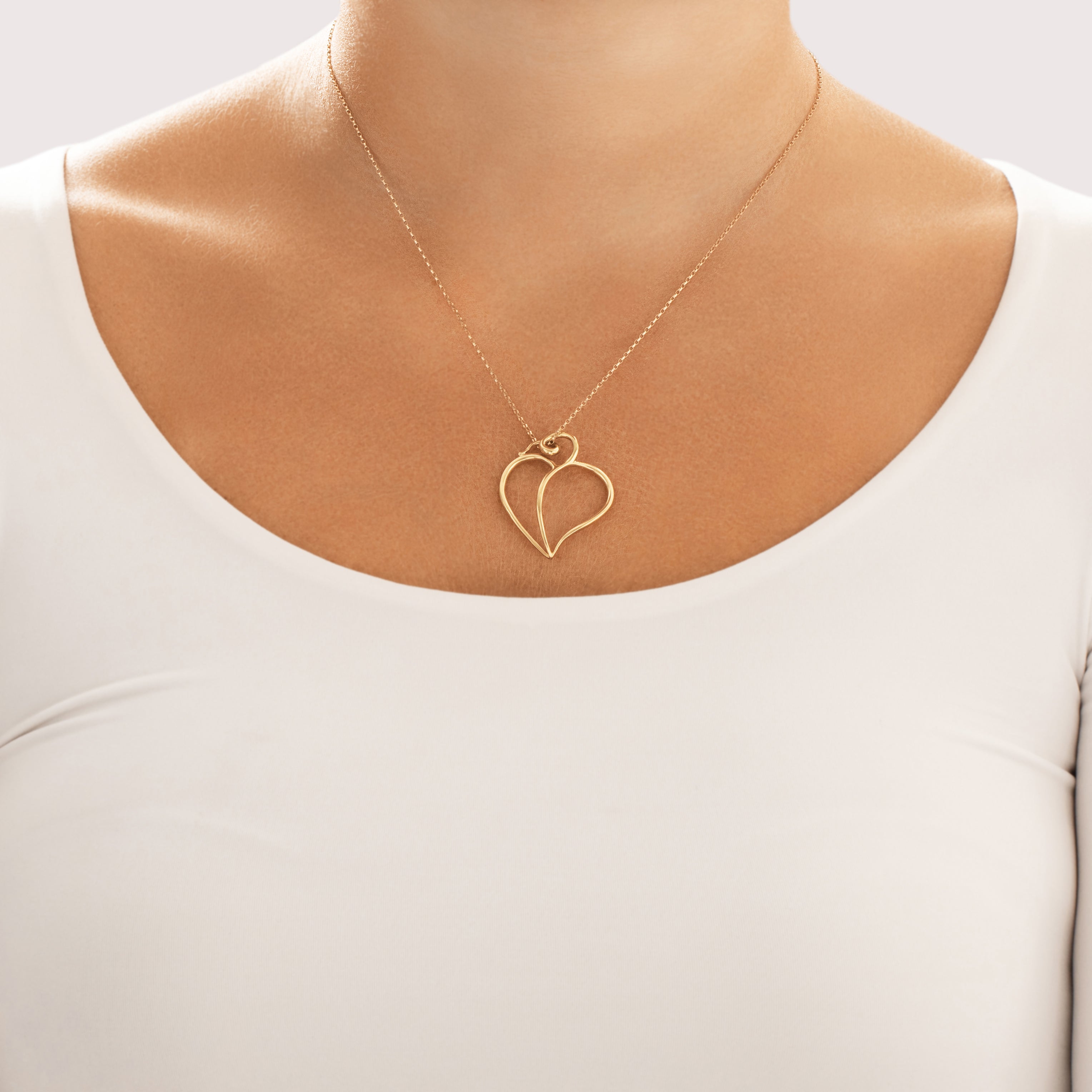 Vintage Tiffany & Co. Paloma Picasso Large 18k Yellow Gold Swirling Heart Tendril Pendant - On model view