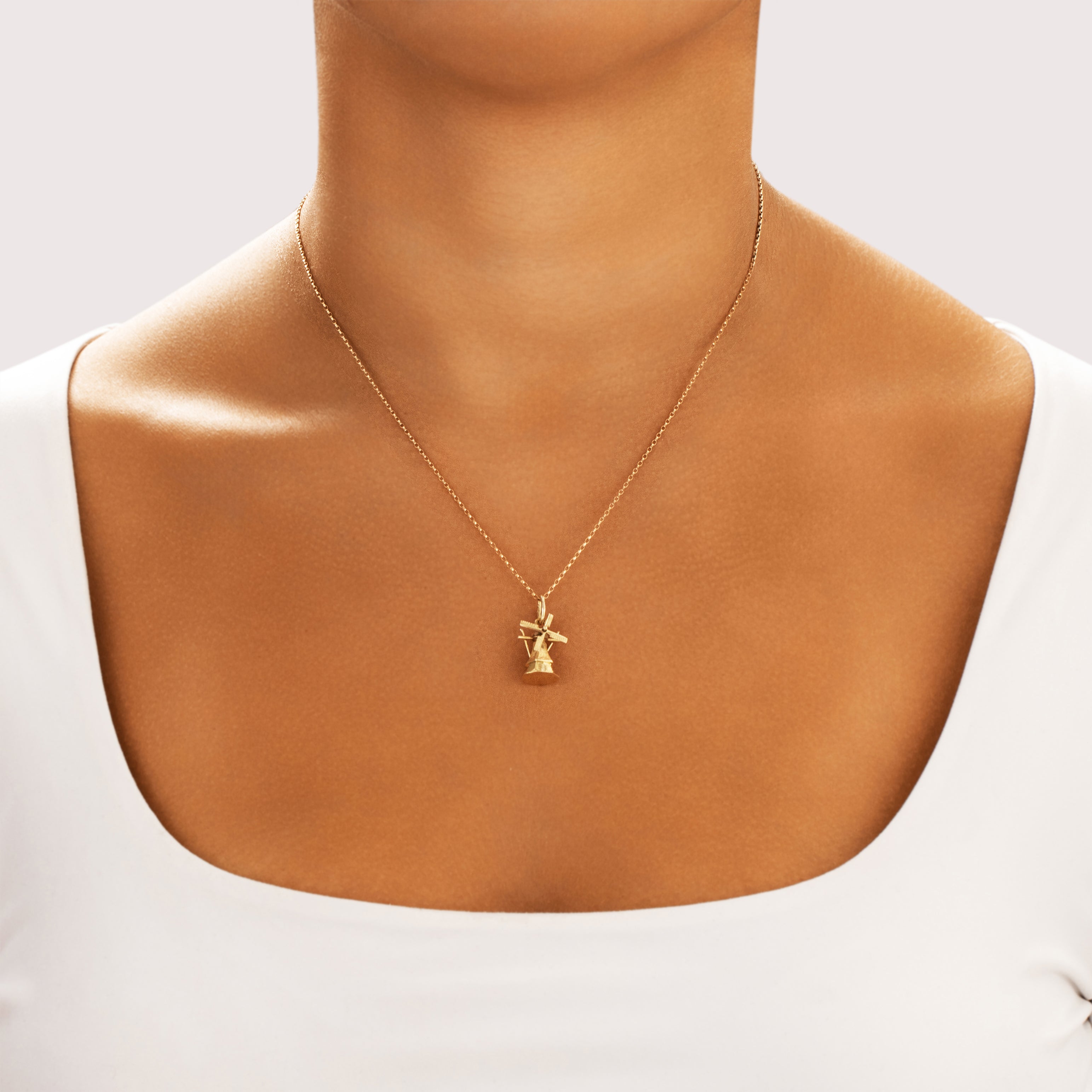 Vintage 14k Yellow Gold Articulating Peaceful Windmill Charm / Pendant - On model view
