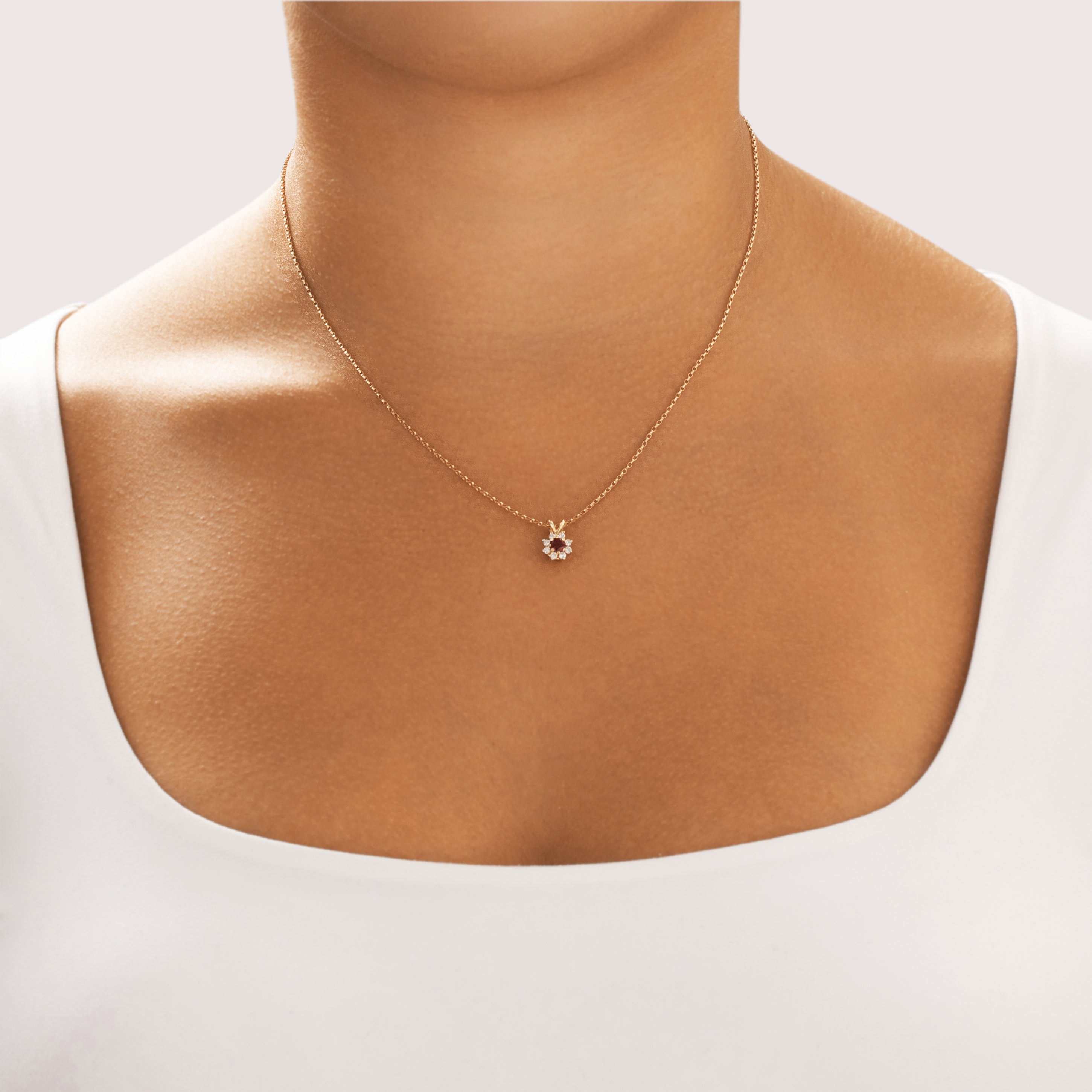 Vintage Small 14k Yellow Gold Garnet Diamond Sparkling Floriform Halo Pendant - On model view
